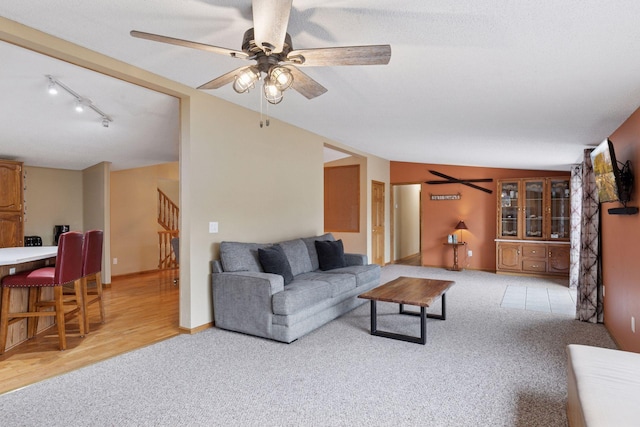 34115 Malmberg Ave, Chisago Lake Twp, MN 55045 - living area with light colored carpet, ceiling fan, and stairs