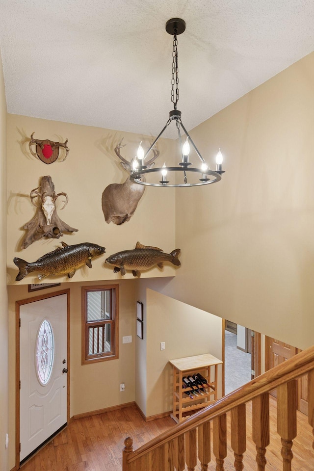 34115 Malmberg Ave, Chisago Lake Twp, MN 55045 - foyer entrance featuring a chandelier, light wood finished floors, and stairway