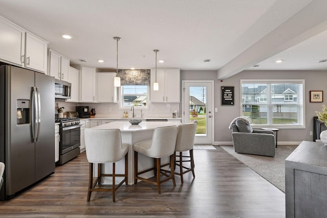 9444 Bridle Way, Victoria, MN 55386 - kitchen with stainless steel appliances, open floor plan, a sink, white cabinetry, and recessed lighting