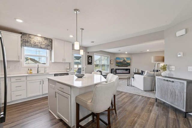 9444 Bridle Way, Victoria, MN 55386 - kitchen with a sink, open floor plan, light countertops, white cabinetry, and recessed lighting