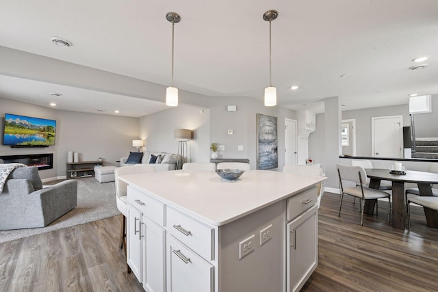 9444 Bridle Way, Victoria, MN 55386 - kitchen with a kitchen island, open floor plan, dark wood-style floors, recessed lighting, and hanging light fixtures