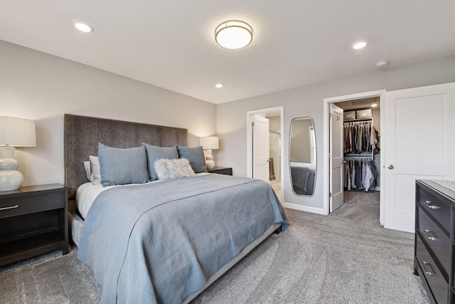 9444 Bridle Way, Victoria, MN 55386 - bedroom featuring light colored carpet, a walk in closet, recessed lighting, ensuite bathroom, and baseboards