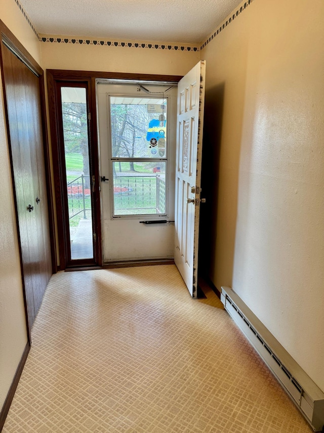 doorway with baseboard heating and baseboards