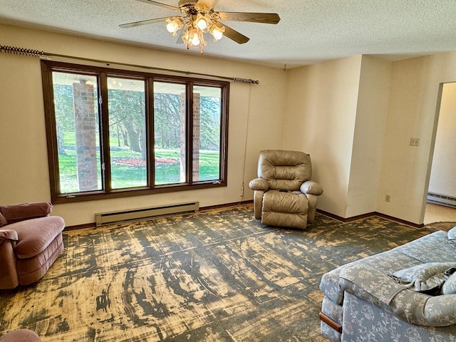 sitting room featuring baseboard heating, a textured ceiling, carpet floors, ceiling fan, and plenty of natural light