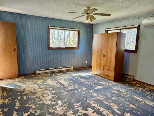 unfurnished bedroom with a baseboard radiator, carpet floors, a textured ceiling, a wall mounted AC, and baseboards