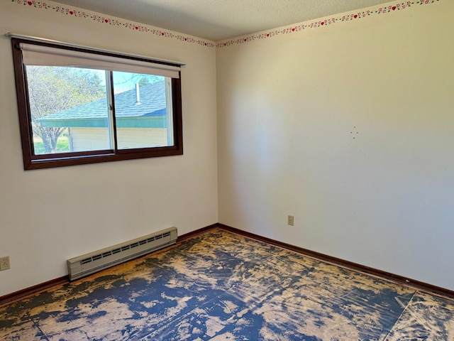 unfurnished room featuring a baseboard radiator and baseboards