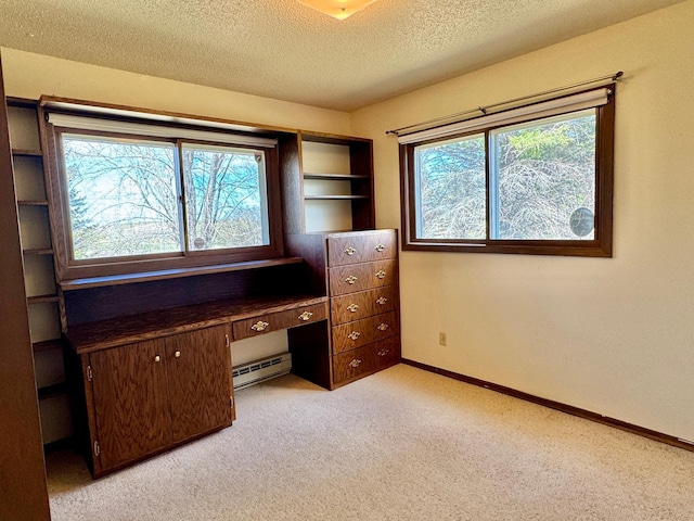 unfurnished office featuring light carpet, a baseboard radiator, a textured ceiling, and baseboards
