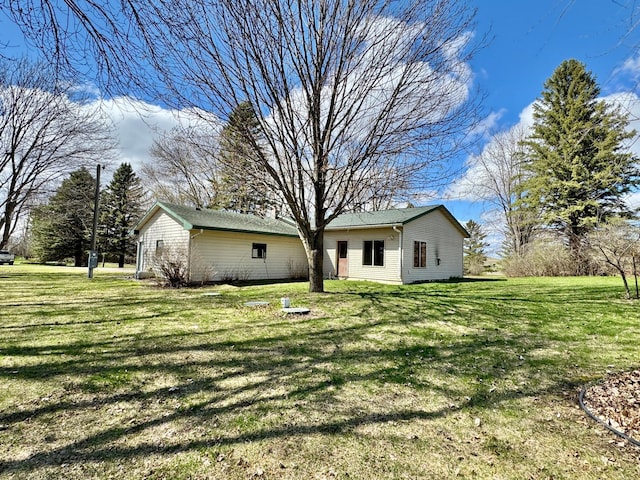back of property featuring a yard