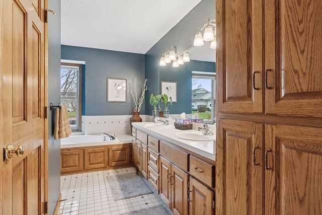 full bath with a garden tub, a sink, and a wealth of natural light