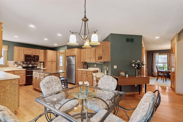dining area featuring visible vents, recessed lighting, a chandelier, and light wood-style floors