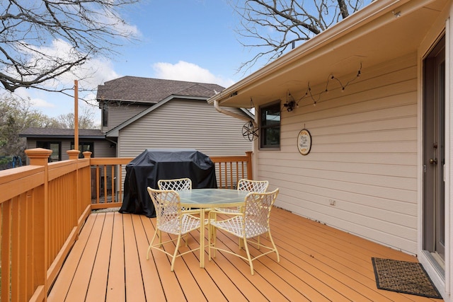 wooden deck featuring outdoor dining area and grilling area