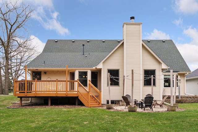 back of house with a lawn, a chimney, a deck, and a shingled roof