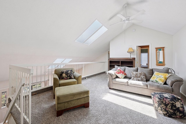 carpeted living area featuring a ceiling fan, vaulted ceiling, and a skylight
