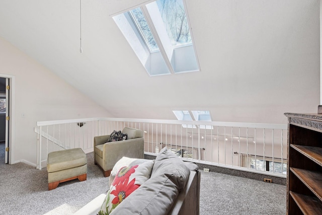 carpeted living room with a skylight and vaulted ceiling