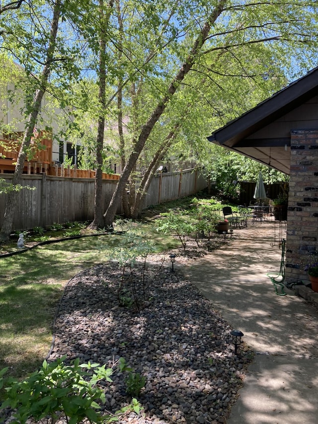 view of yard with fence and a patio area