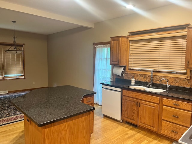 10822 Steamboat Loop NW, Walker, MN 56484 - kitchen featuring white dishwasher, tasteful backsplash, a kitchen island, light wood finished floors, and brown cabinetry