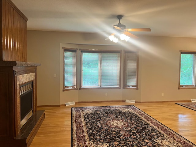 10822 Steamboat Loop NW, Walker, MN 56484 - unfurnished living room with light wood finished floors, ceiling fan, and a glass covered fireplace