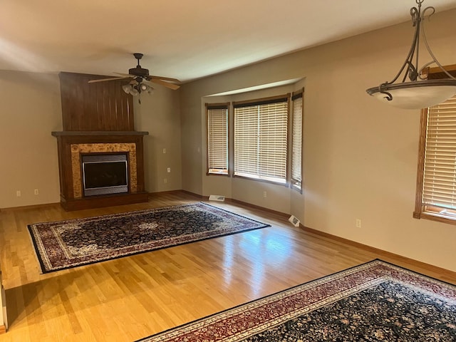 10822 Steamboat Loop NW, Walker, MN 56484 - unfurnished living room featuring ceiling fan, wood finished floors, and a large fireplace
