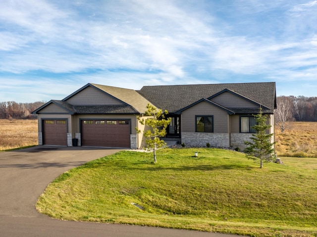 21107 Ghia St NE, East Bethel, MN 55011 - ranch-style home featuring a front yard, an attached garage, stone siding, and aphalt driveway