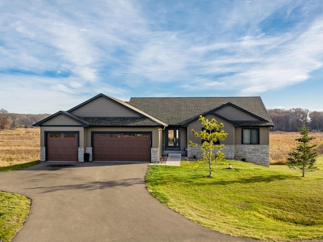21107 Ghia St NE, East Bethel, MN 55011 - view of front of property with a front yard, a shingled roof, an attached garage, stone siding, and aphalt driveway
