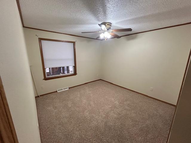 54966 Rainbow Rd, Sand Lake Twp, MN 56636 - carpeted spare room with a ceiling fan, ornamental molding, and a textured ceiling