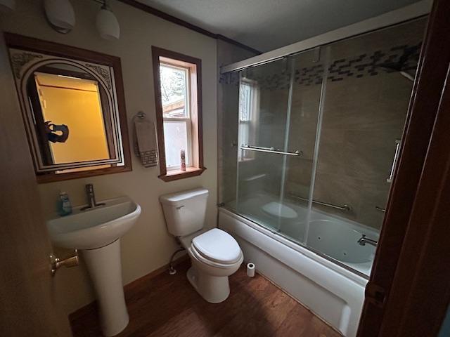 54966 Rainbow Rd, Sand Lake Twp, MN 56636 - bathroom featuring wood finished floors, combined bath / shower with glass door, and crown molding