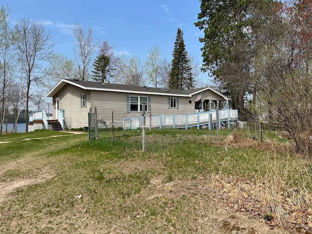 54966 Rainbow Rd, Sand Lake Twp, MN 56636 - back of house with a wooden deck, a lawn, and a pool