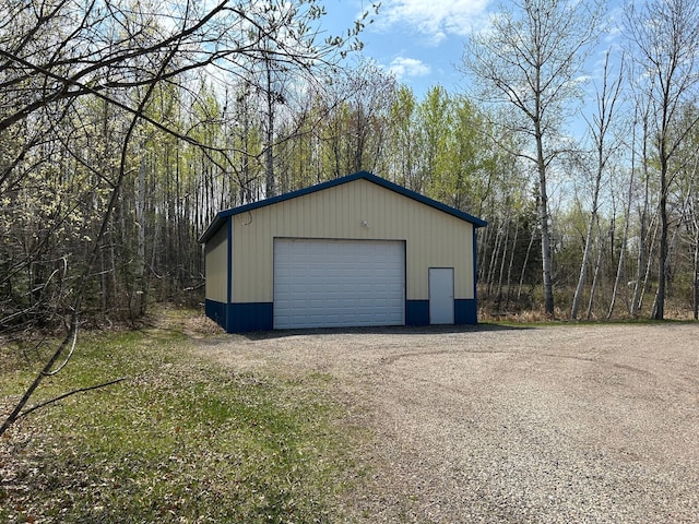 54966 Rainbow Rd, Sand Lake Twp, MN 56636 - detached garage featuring a view of trees
