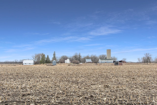 view of yard with an outdoor structure and a rural view