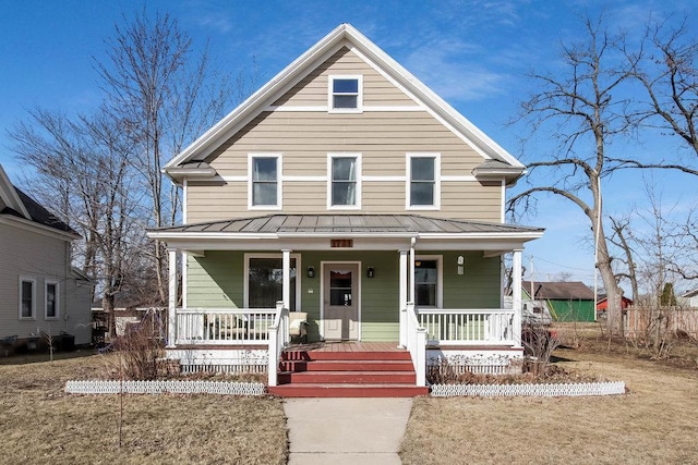 traditional style home featuring a standing seam roof, metal roof, and a porch