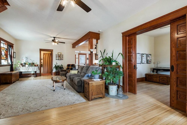 living room featuring a healthy amount of sunlight, a ceiling fan, and wood-type flooring