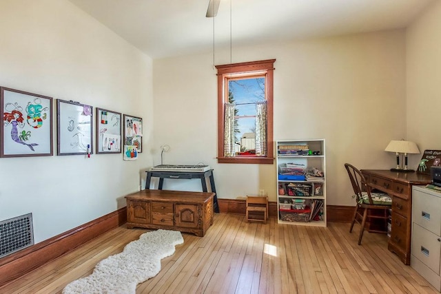 office space featuring visible vents, light wood-style flooring, and baseboards