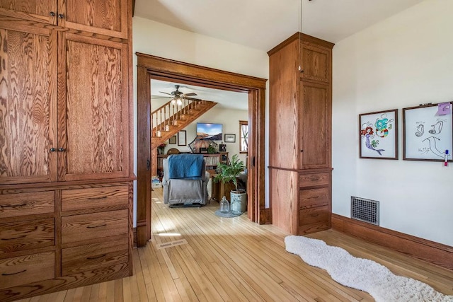 corridor featuring visible vents and light wood-style floors