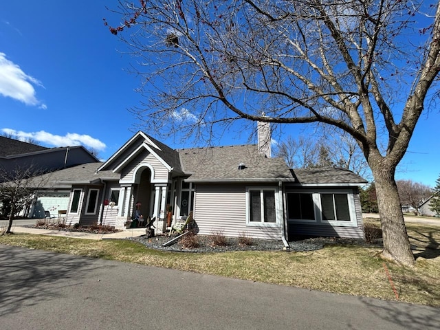 2548 Sumac Rdg, White Bear Lake, MN 55110 - ranch-style home with an attached garage, a front lawn, roof with shingles, and a chimney