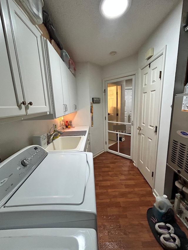 2548 Sumac Rdg, White Bear Lake, MN 55110 - laundry room featuring cabinet space, a sink, baseboards, dark wood-style floors, and washer and clothes dryer