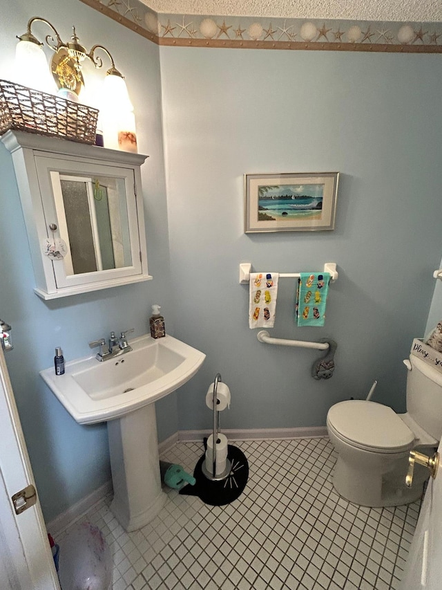2548 Sumac Rdg, White Bear Lake, MN 55110 - bathroom featuring toilet, baseboards, and tile patterned flooring