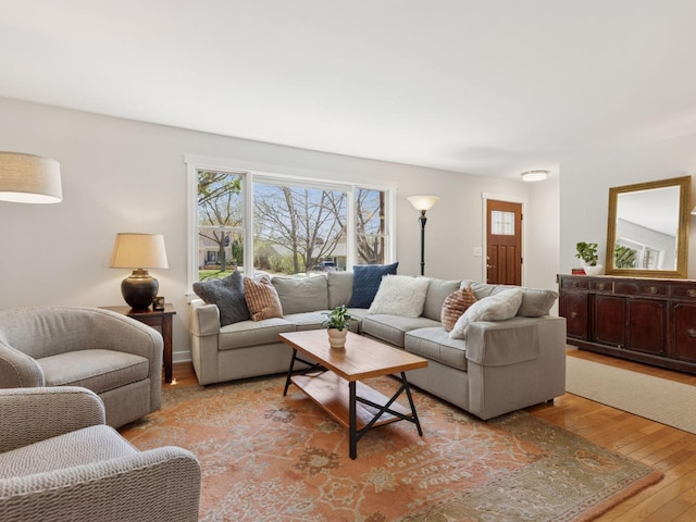 living area featuring light wood-type flooring and healthy amount of natural light