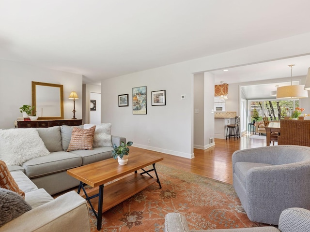 living room with wood finished floors and baseboards