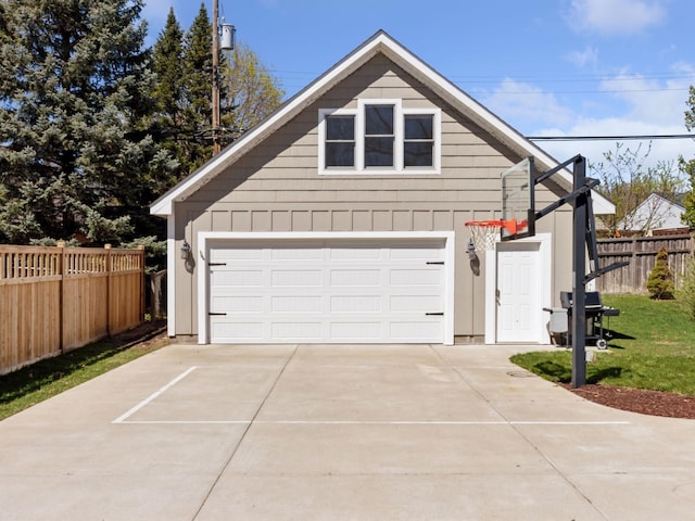 view of home's exterior featuring driveway, fence, and an attached garage