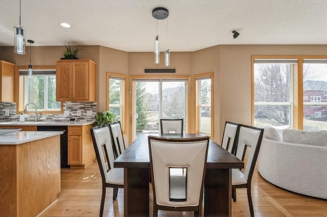 11373 Balsam Way, Woodbury, MN 55129 - dining area with a textured ceiling, recessed lighting, and light wood-style floors