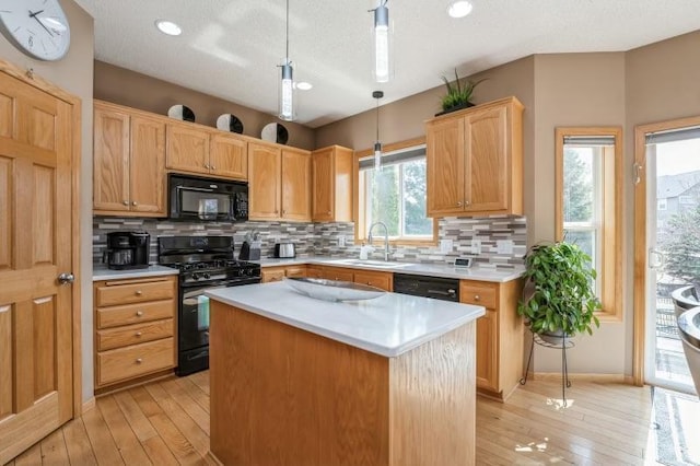 11373 Balsam Way, Woodbury, MN 55129 - kitchen with light wood-style flooring, light countertops, black appliances, and decorative backsplash