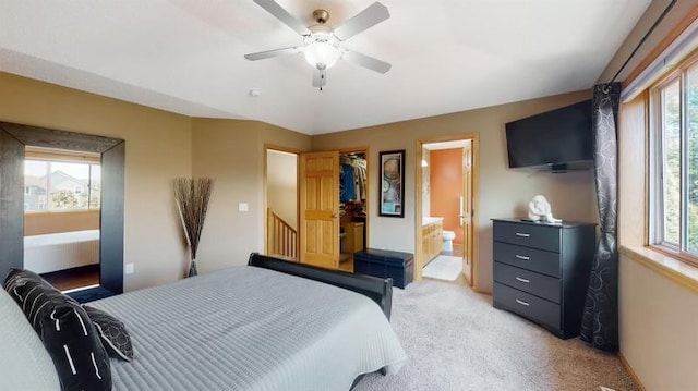 11373 Balsam Way, Woodbury, MN 55129 - bedroom with ensuite bathroom, a closet, a ceiling fan, light carpet, and a walk in closet