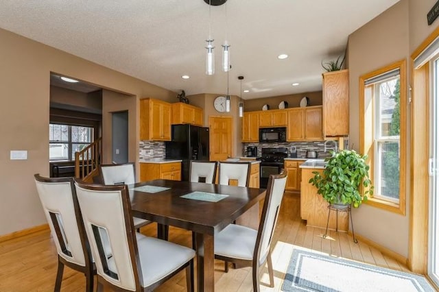 11373 Balsam Way, Woodbury, MN 55129 - dining area featuring recessed lighting, light wood-style floors, and baseboards