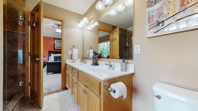 11373 Balsam Way, Woodbury, MN 55129 - bathroom featuring toilet, ceiling fan, double vanity, and a sink