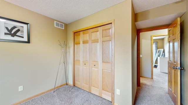11373 Balsam Way, Woodbury, MN 55129 - unfurnished bedroom with a textured ceiling, a closet, carpet flooring, and baseboards
