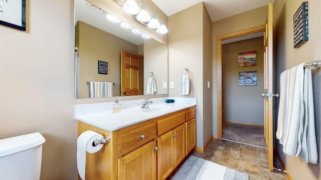 11373 Balsam Way, Woodbury, MN 55129 - bathroom with toilet, stone finish floor, vanity, and baseboards