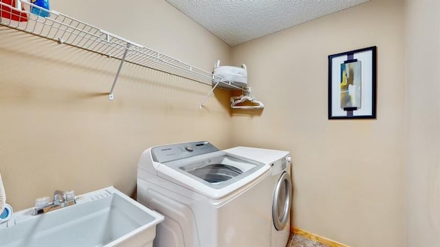 11373 Balsam Way, Woodbury, MN 55129 - laundry room with a sink, separate washer and dryer, laundry area, and a textured ceiling