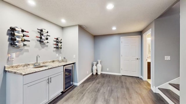 11373 Balsam Way, Woodbury, MN 55129 - bar featuring light wood-style floors, wet bar, a sink, and recessed lighting