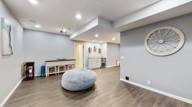 11373 Balsam Way, Woodbury, MN 55129 - exercise area with wine cooler, baseboards, and wood finished floors