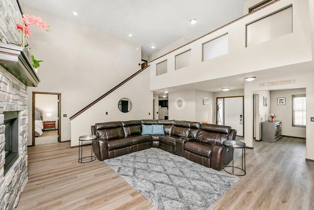 1408 72nd Ave S, Fargo, ND 58104 - living area with light wood finished floors, a high ceiling, a fireplace, recessed lighting, and baseboards